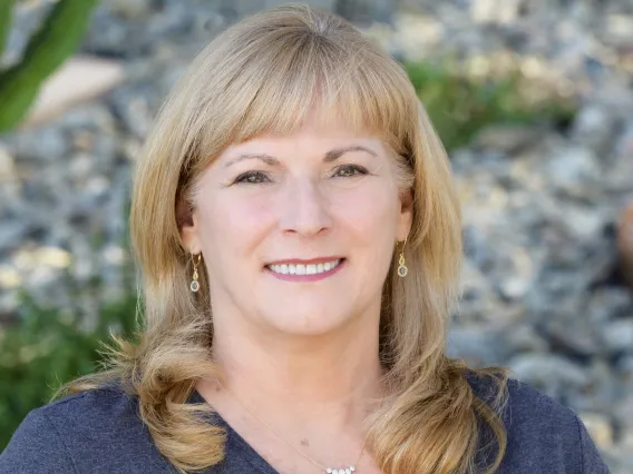 Headshot of Annette Maggio wearing a gray shirt