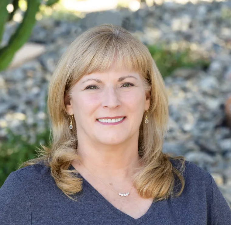 Headshot of Annette Maggio wearing a gray shirt