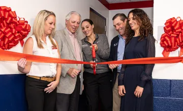 Head Women's Basketball Coach Adia Barnes cutting red ribbon for McKale Lactation Room